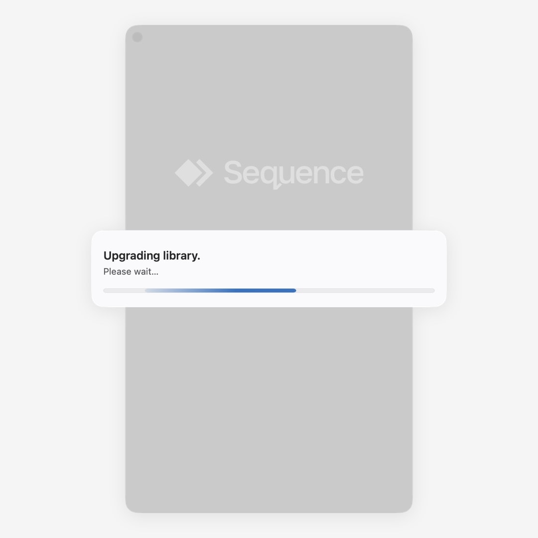 Sequence showing an Upgrading library progress dialog while it prepares the library
